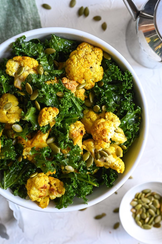 A delicious plant-based salad starring roasted cauliflower, chopped kale and with a wonderful vinaigrette