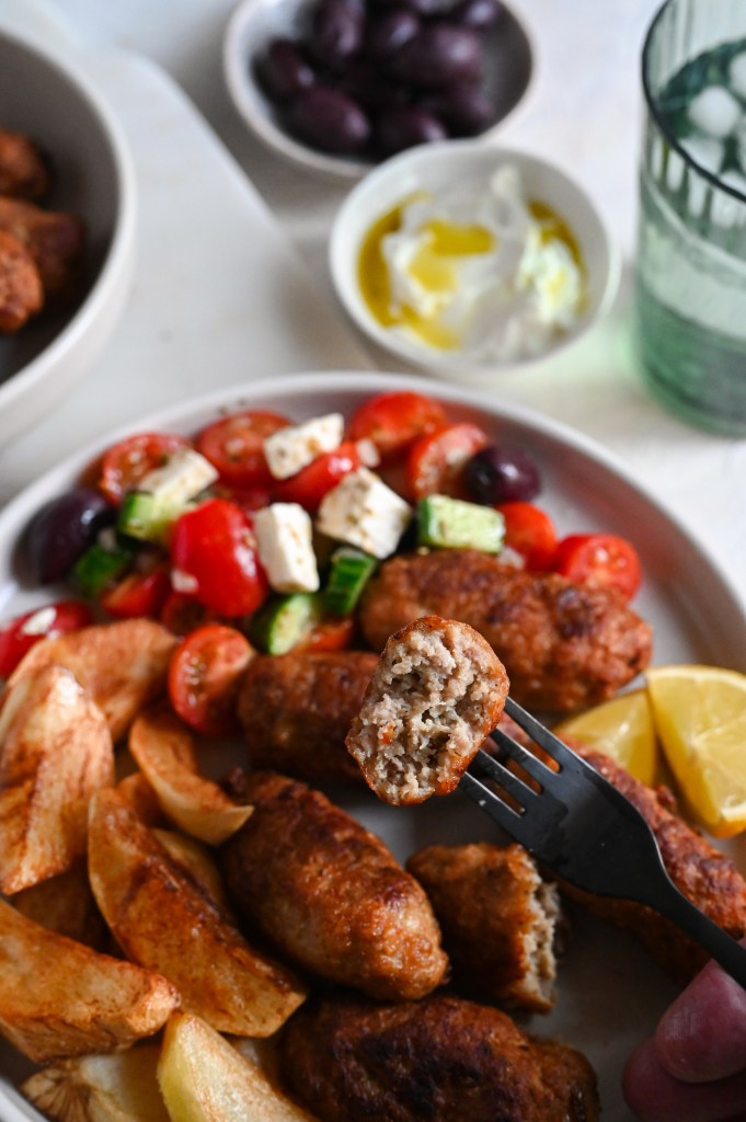 Biftekia with french fries is a classic Greek meal of meat patties and fried potatoes.