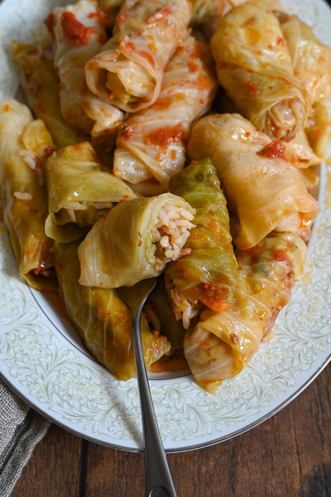 Lahanodolmades, Greek stuffed cabbage rolls with tomato sauce.